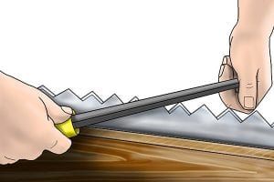 Using a file to sharpen a crosscut saw