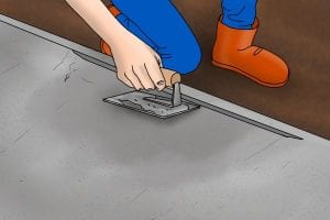 Using an edging tool to round off the edges of the newly floated contcrete.