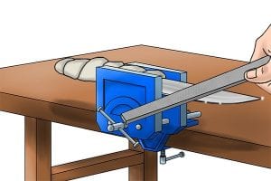 Step 3: Using a shallow angle apply the file against the blade