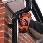 BLACK+DECKER hammer drill drilling into a brick wall