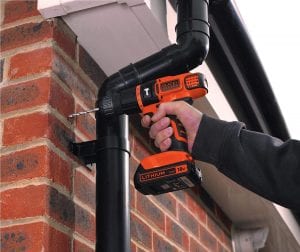 BLACK+DECKER hammer drill drilling into a brick wall