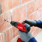 Hilti SF 6H-A22 Cordless Hammer Drill Driver 3 drilling through a brick wall by a masonry worker