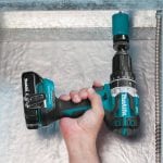 Makita cordless hammer drill cutting through metal