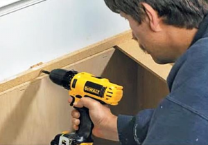 How to use a DeWalt cordless screwdriver to screw into the wall.