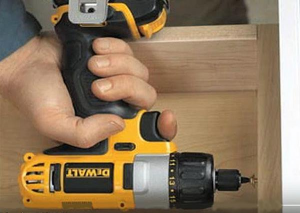 Putting together a draw with a cordless DeWalt screwdriver.