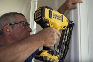 Individual using a DeWalt nailer within a home.