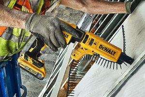 Drywall screwdriver being used with collated screw magazine.